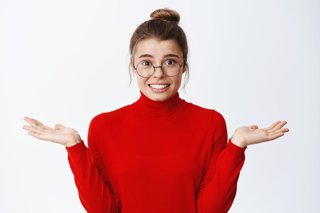 I dont know. Confused blond female entrepreneur in glasses, spre